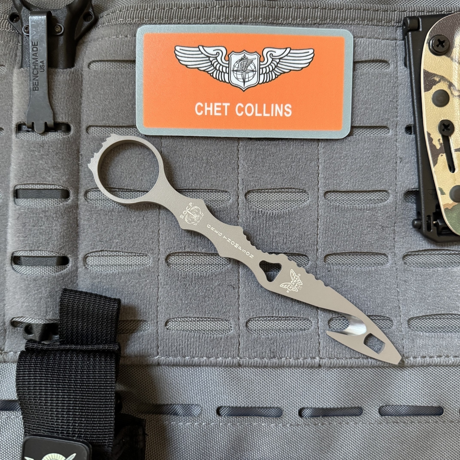 Benchmade SOCP Rescue Tool laid out on top of a weighted workout vest